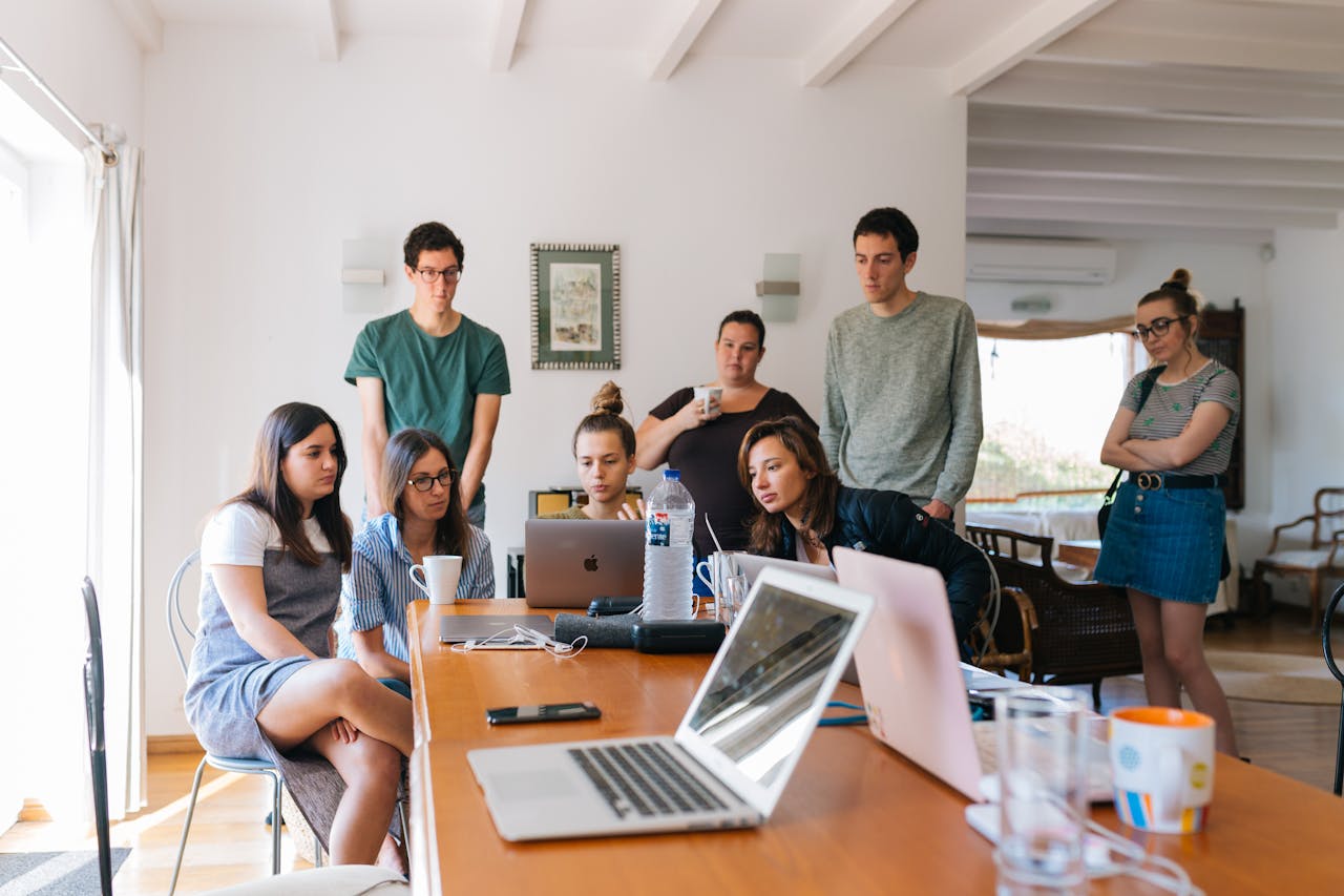 The Art of Drawing Readers In: Your attractive post title goes here Group of young professionals engaged in a collaborative meeting in a modern office setting.